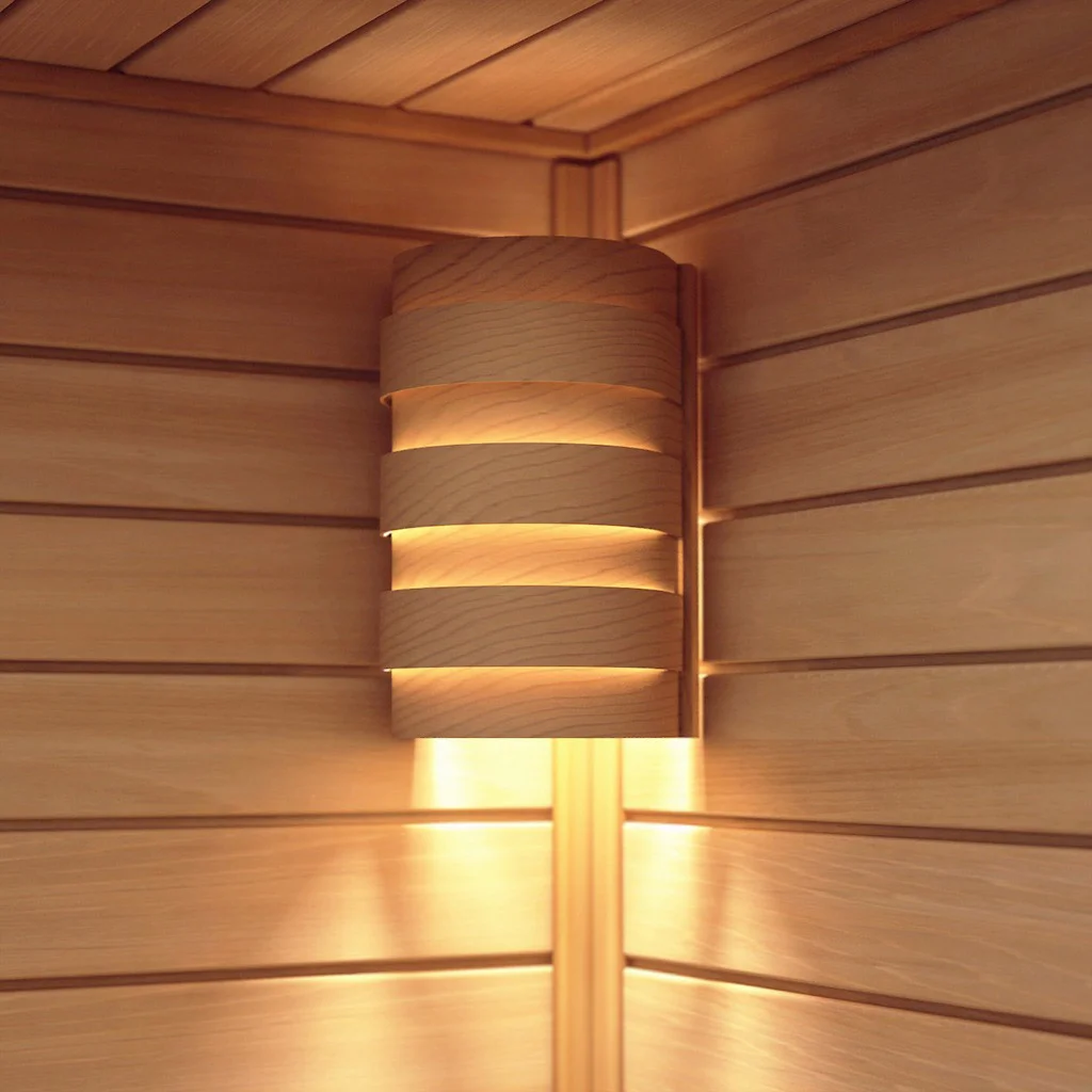 Wooden SAWO corner light cover glowing warmly on a sauna wall
