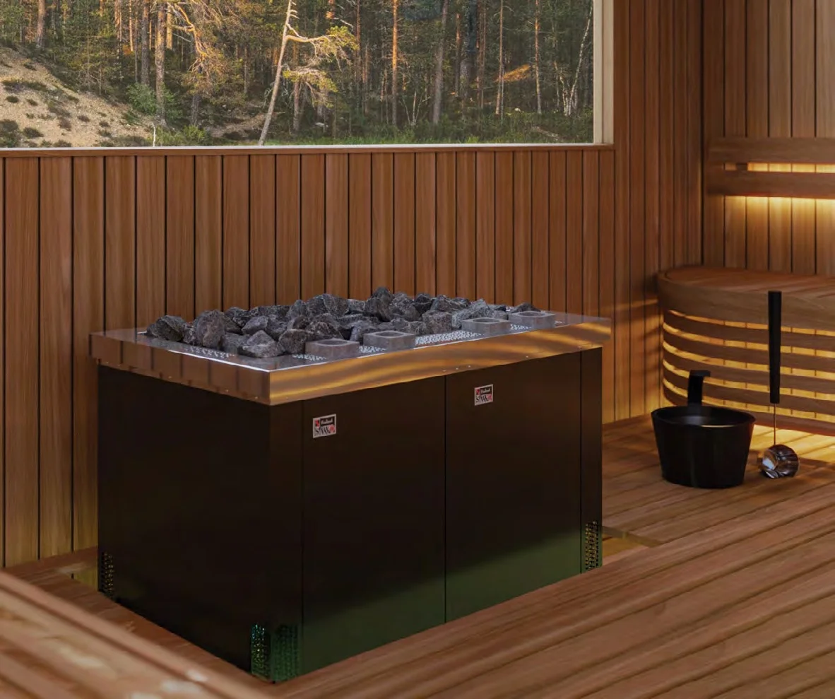 SAWO Taurus D Combi black commercial heater beside a forest-view window