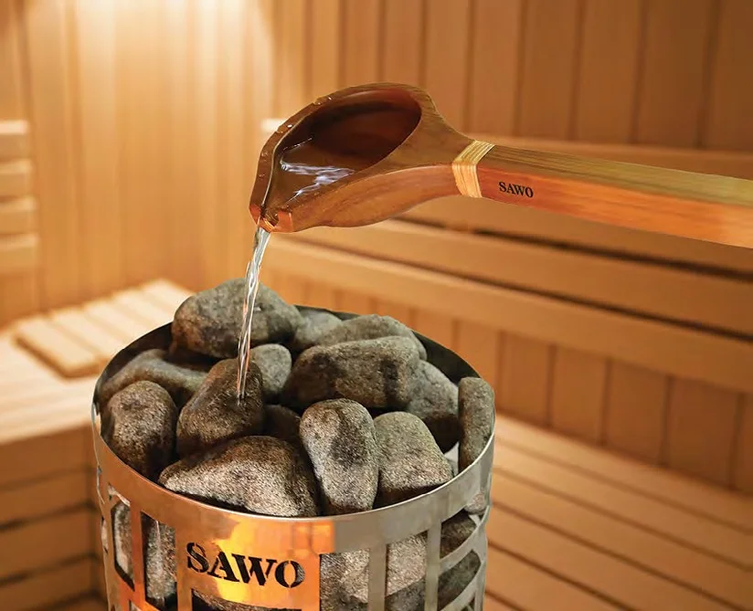 SAWO wooden ladle pouring water over sauna stones