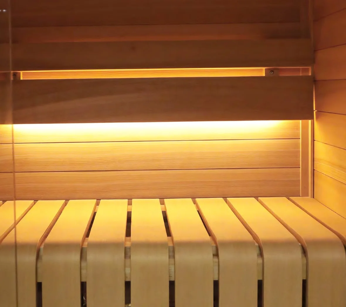 Warm SAWO LED light strip installed under a sauna bench edge